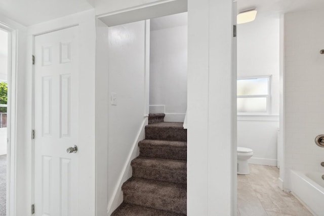 staircase featuring baseboards