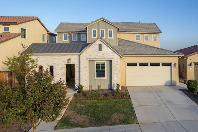 view of front of home with an attached garage, board and batten siding, driveway, and fence