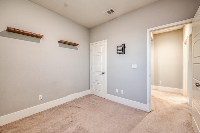 carpeted empty room with baseboards and visible vents