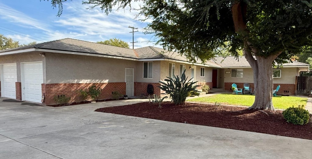 ranch-style house with a garage and a front lawn