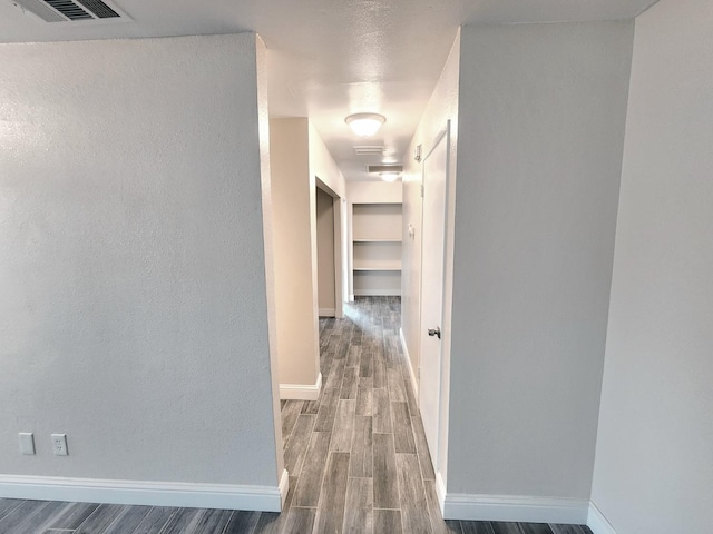 corridor with wood-type flooring