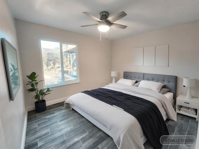 bedroom with dark hardwood / wood-style floors and ceiling fan