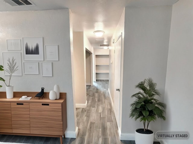 corridor with wood-type flooring