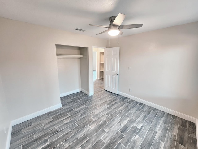 unfurnished bedroom with hardwood / wood-style flooring, a closet, and ceiling fan