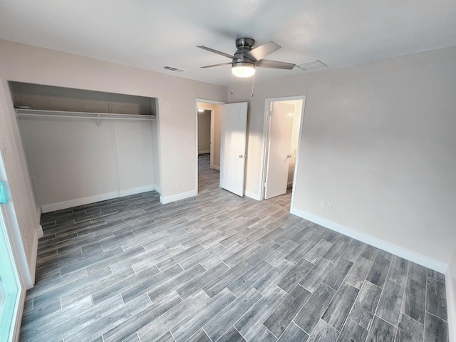 unfurnished bedroom with hardwood / wood-style floors, a closet, and ceiling fan