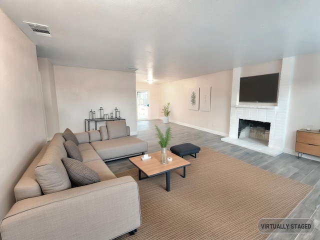 living room featuring a fireplace and hardwood / wood-style floors