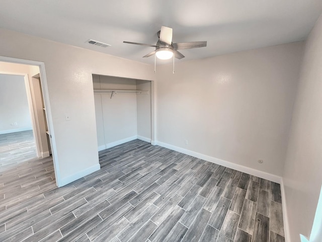 unfurnished bedroom with a closet, ceiling fan, and hardwood / wood-style floors