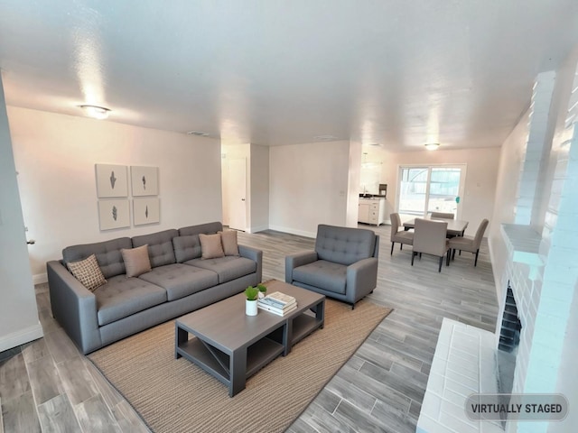 living room featuring hardwood / wood-style flooring and a fireplace