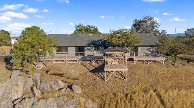 back of property with a wooden deck