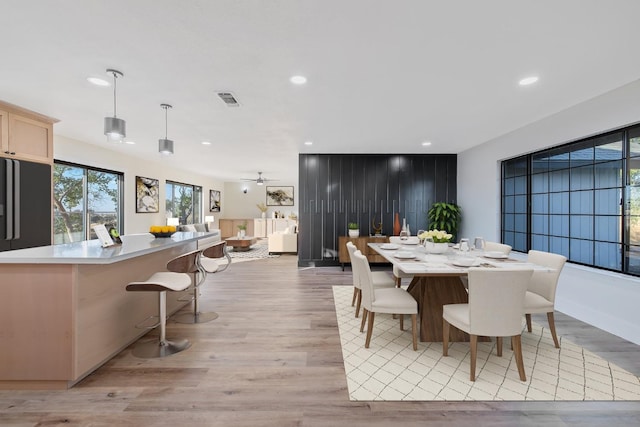 dining room featuring light hardwood / wood-style floors and ceiling fan