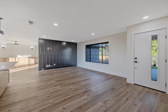 interior space featuring light wood-type flooring and ceiling fan