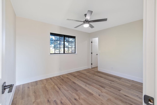 spare room featuring light hardwood / wood-style floors and ceiling fan