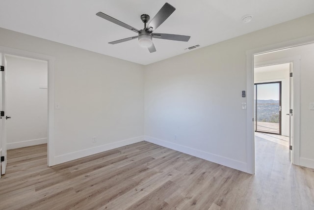 empty room featuring light hardwood / wood-style flooring and ceiling fan