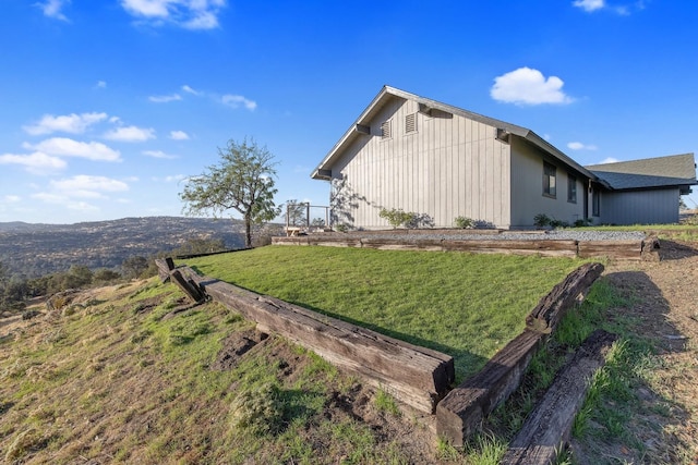 view of side of property with a lawn