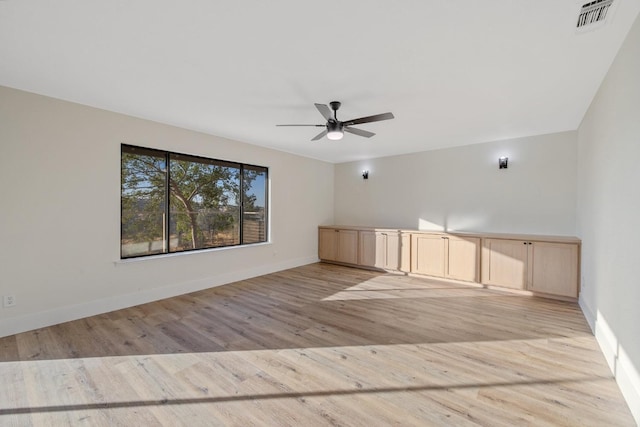 empty room featuring light hardwood / wood-style flooring and ceiling fan