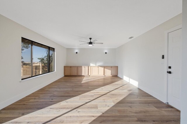 interior space featuring light wood-type flooring and ceiling fan