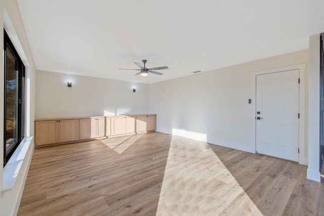 unfurnished living room featuring light hardwood / wood-style floors and ceiling fan