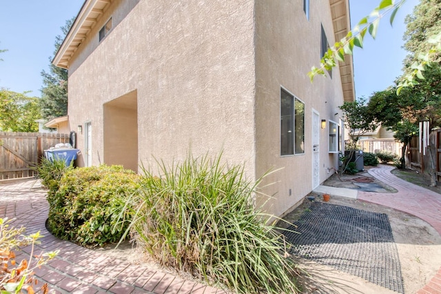 view of property exterior with a patio area