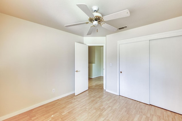 unfurnished bedroom with a closet, ceiling fan, and light wood-type flooring