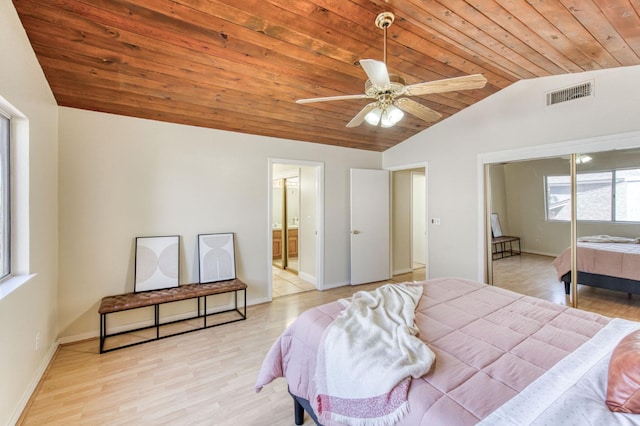 bedroom featuring wood ceiling, ceiling fan, light wood-type flooring, vaulted ceiling, and ensuite bath