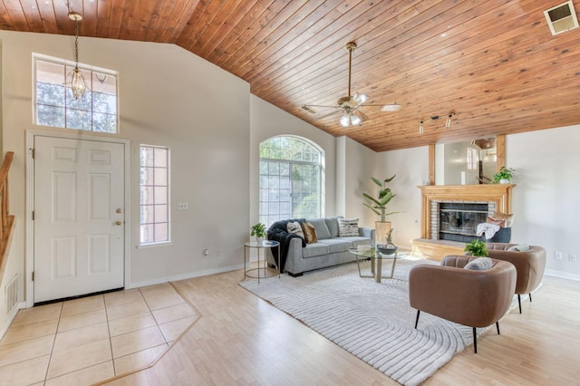 living room with light hardwood / wood-style floors, high vaulted ceiling, wooden ceiling, and ceiling fan with notable chandelier