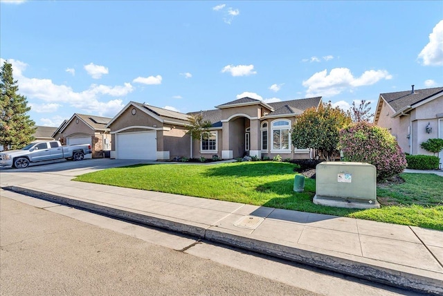 view of front of property featuring a front yard and a garage