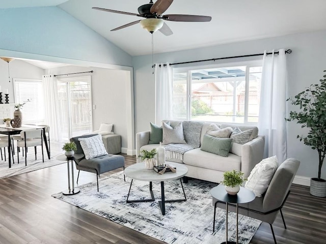 living room featuring a wealth of natural light, ceiling fan, wood-type flooring, and vaulted ceiling