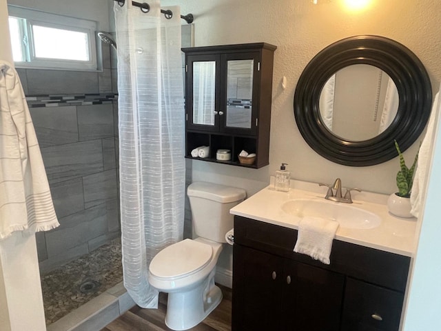 bathroom with a shower with curtain, vanity, toilet, and wood-type flooring