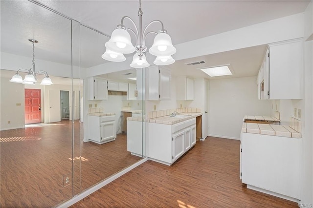 49400 River Park Rd Unit 17, Oakhurst, CA 93644 - kitchen with a chandelier, tile counters, and dark wood-style floors