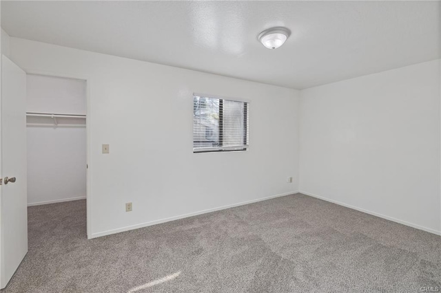 49400 River Park Rd Unit 17, Oakhurst, CA 93644 - unfurnished bedroom with carpet flooring, a spacious closet, a closet, and baseboards