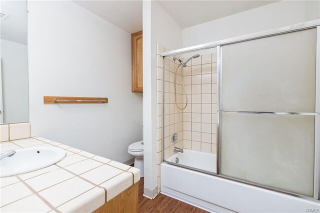 49400 River Park Rd Unit 17, Oakhurst, CA 93644 - bathroom with toilet, vanity, bath / shower combo with glass door, and wood finished floors