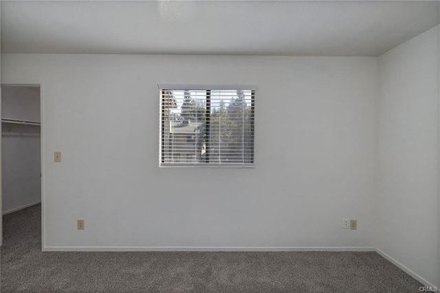 49400 River Park Rd Unit 17, Oakhurst, CA 93644 - unfurnished bedroom with a spacious closet, carpet flooring, baseboards, and a closet