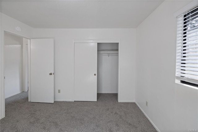 49400 River Park Rd Unit 17, Oakhurst, CA 93644 - unfurnished bedroom with carpet floors, a closet, and baseboards
