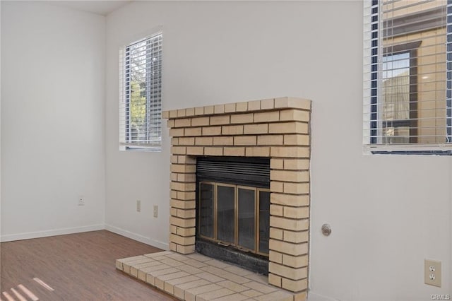 49400 River Park Rd Unit 17, Oakhurst, CA 93644 - detailed view of a fireplace, wood finished floors, and baseboards