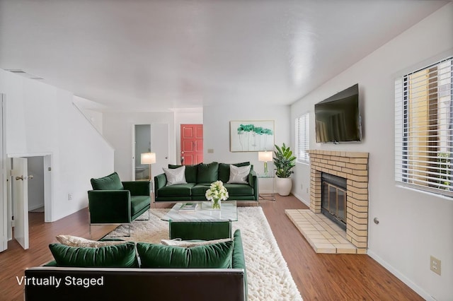 49400 River Park Rd Unit 17, Oakhurst, CA 93644 - living area with wood finished floors, a brick fireplace, baseboards, and stairs