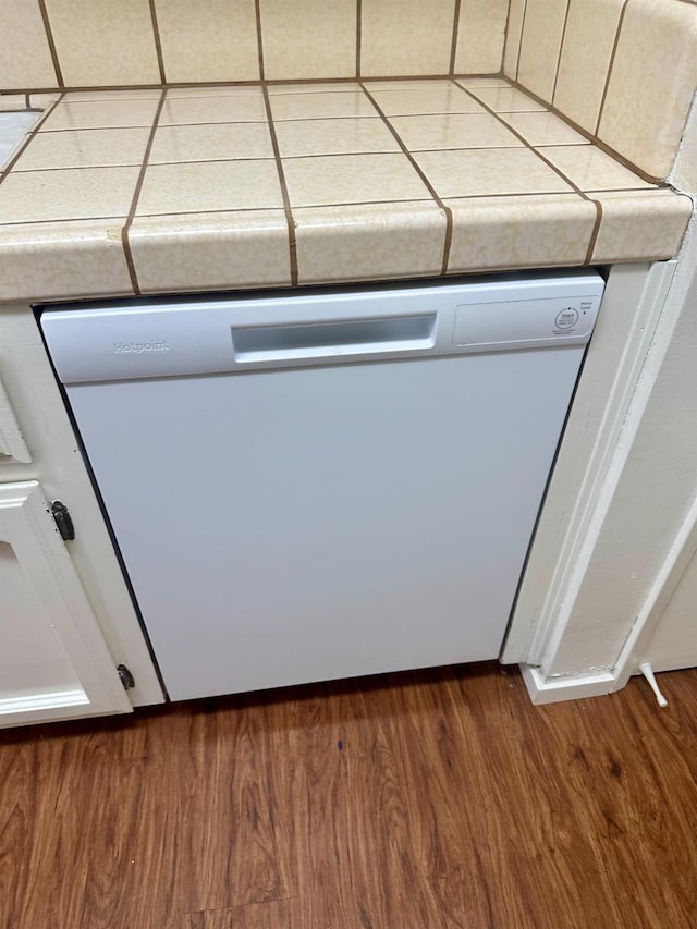 49400 River Park Rd Unit 17, Oakhurst, CA 93644 - detailed view of white dishwasher, dark wood finished floors, and tile counters