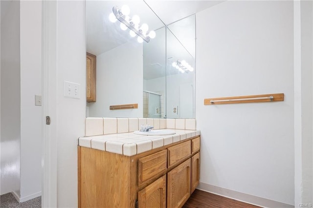 49400 River Park Rd Unit 17, Oakhurst, CA 93644 - full bathroom with vanity, a shower with shower door, and baseboards
