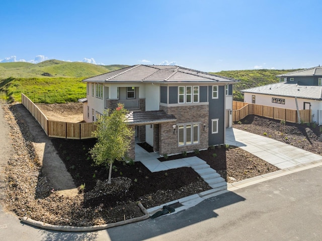 view of front of house featuring a mountain view and a patio area