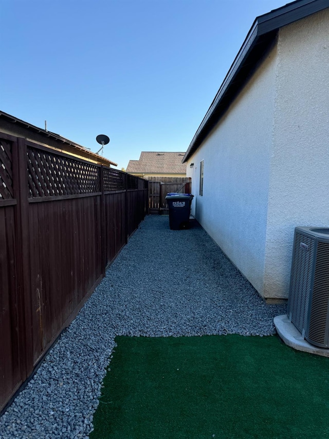 view of yard featuring central air condition unit and a patio area