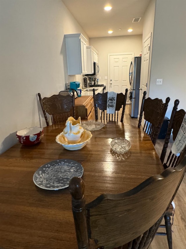 dining space with light wood-type flooring