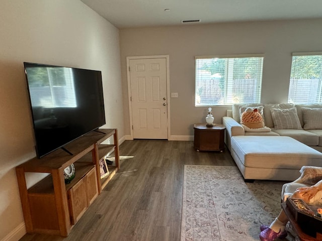 living room with dark hardwood / wood-style flooring