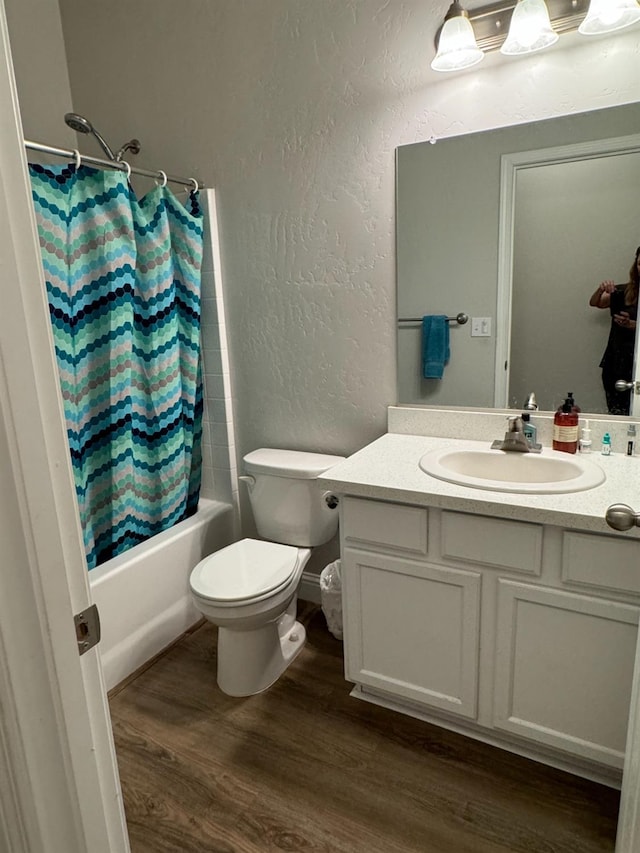 full bathroom with vanity, toilet, shower / bath combo with shower curtain, and wood-type flooring