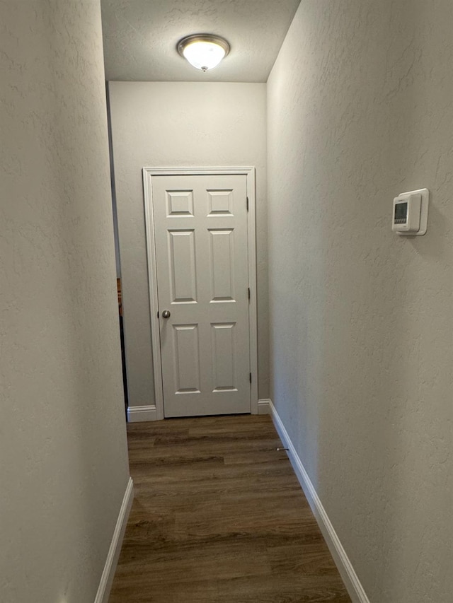 corridor with dark wood-type flooring