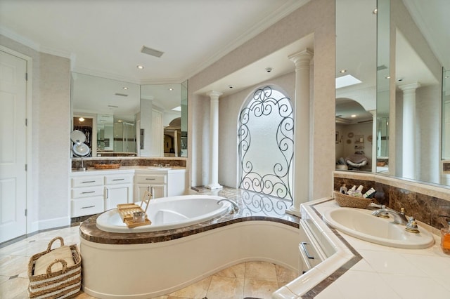 bathroom with tiled bath, ornamental molding, ornate columns, and vanity