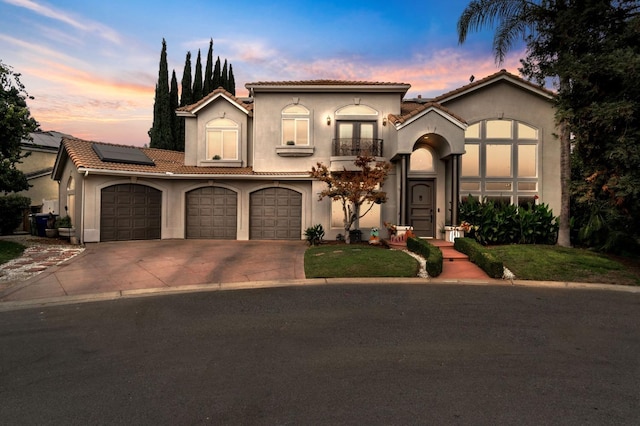 mediterranean / spanish house with solar panels and a garage