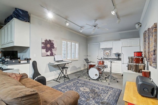 interior space with track lighting, ceiling fan, and crown molding