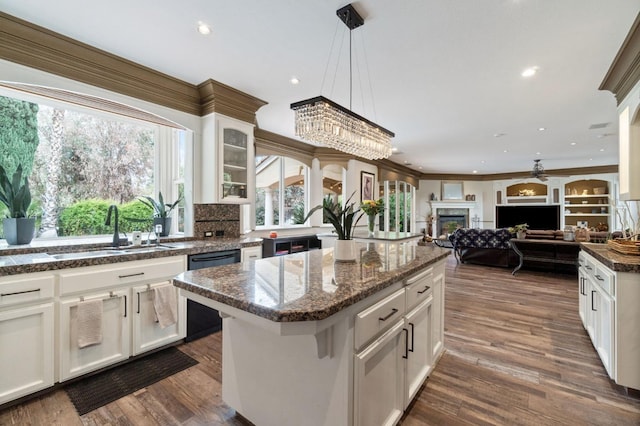 kitchen featuring sink, white cabinets, and a center island