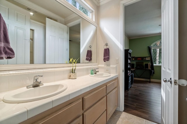 bathroom featuring vanity, ornamental molding, and a wealth of natural light