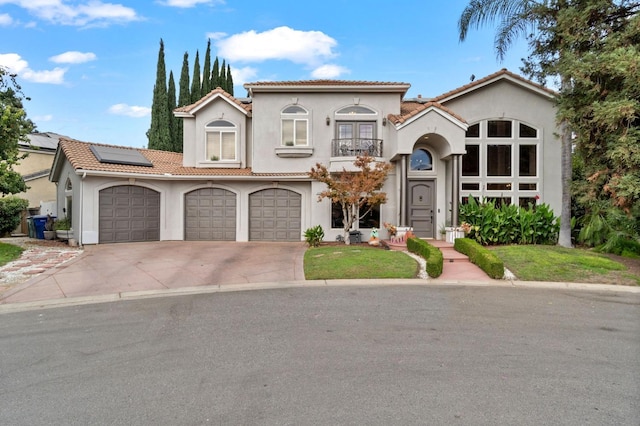 mediterranean / spanish home with a garage and solar panels