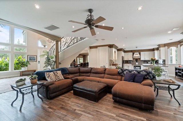 living room featuring ceiling fan and wood-type flooring